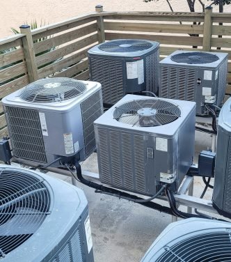 Air conditioners raised platforms at beach serviced by HVAC technicians .